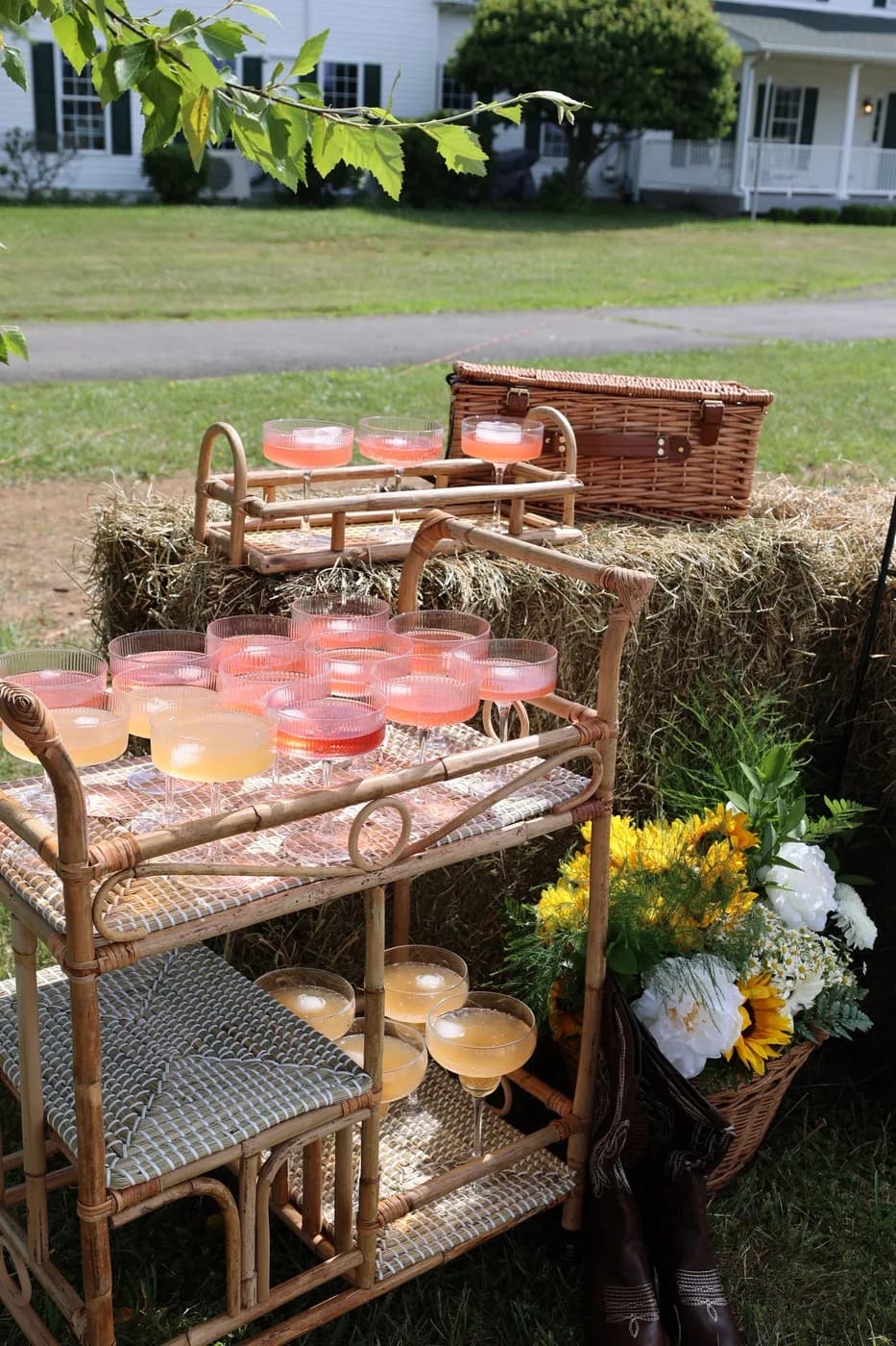 Rattan cocktail cart with spritzes on hay bales with sunflowers at a Mind & Body Retreats Horses & Pilates picnic in Northern Virginia