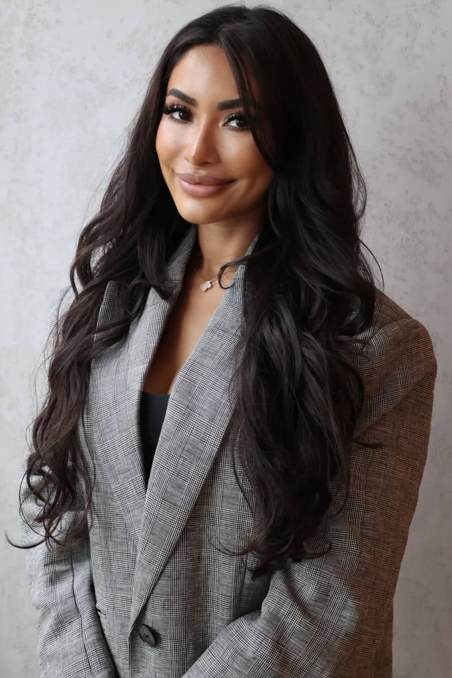 Shanya Taylor, Pilates instructor and partner at Mind & Body Retreats, in a grey check blazer