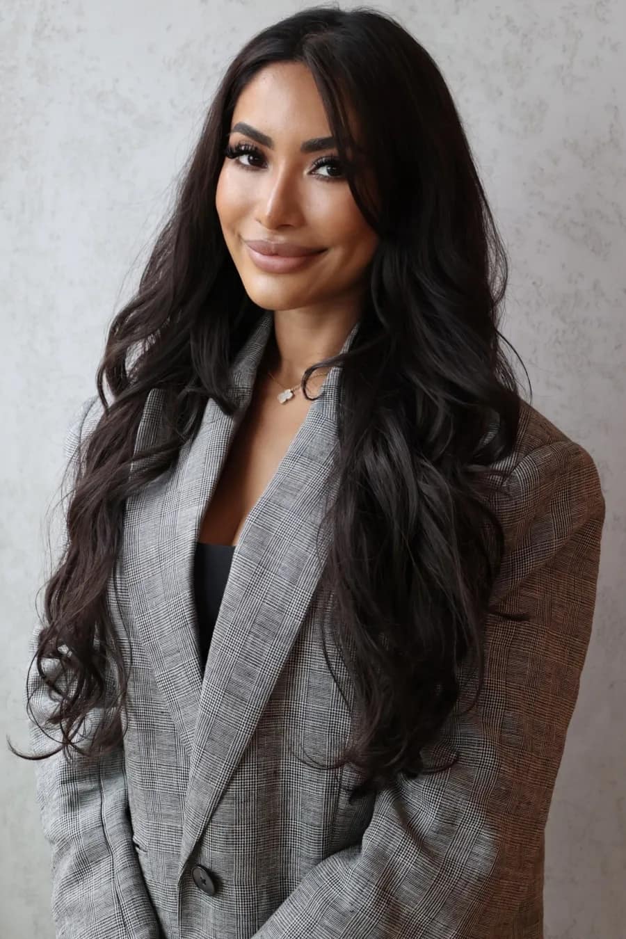 Shanya Taylor, Pilates instructor and partner at Mind & Body Retreats, in a grey check blazer